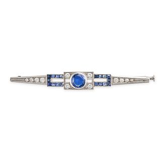 A SAPPHIRE AND DIAMOND BAR BROOCH in platinum, set to the centre with a round cut sapphire of app...