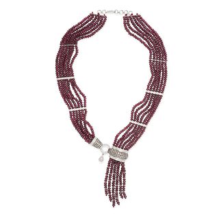 A RUBY AND DIAMOND TASSEL NECKLACE in 18ct white gold,Â comprising six rows of faceted ruby beads ...