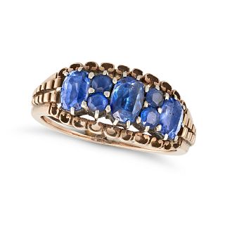 A SAPPHIRE RING in rose gold, set with three cushion cut sapphires punctuated by pairs of round c...