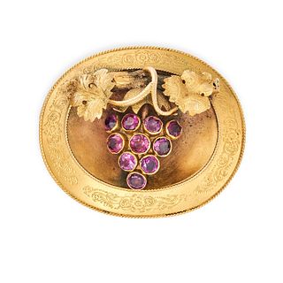 AN ANTIQUE GARNET GRAPE LOCKET / BROOCH in yellow gold, the oval body with an applied bunch of gr...