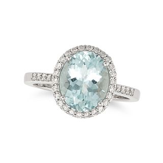 AN AQUAMARINE AND DIAMOND HALO RING in 18ct white gold, set with an oval cut aquamarine of 2.60 c...