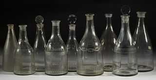 ASSORTED FREE-BLOWN PRUSSIAN-FORM DECANTERS, LOT OF NINE