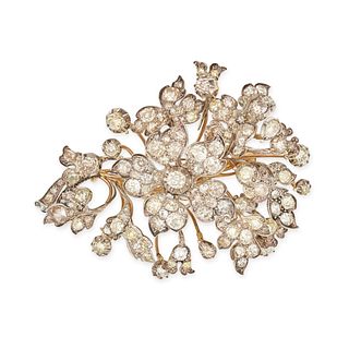 AN ANTIQUE DIAMOND EN TREMBLANT FLORAL BROOCH in 18ct yellow gold and silver, designed as a flora...
