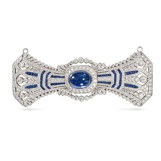 A SAPPHIRE AND DIAMOND BOW BROOCH in 18ct white gold, set to the centre with a cabochon cut sapph...
