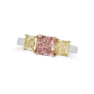A PINK AND YELLOW DIAMOND THREE STONE RING in yellow gold and platinum, set with a radiant cut pi...