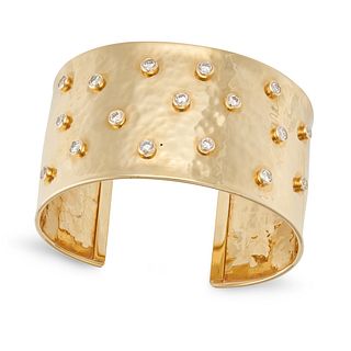 A DIAMOND CUFF BANGLE in 14ct yellow gold, the hammered open cuff bangle set with round brilliant...