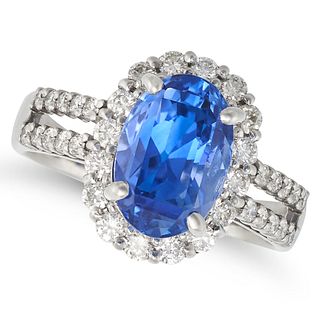 A CEYLON NO HEAT SAPPHIRE AND DIAMOND RING in platinum, set with an oval cut sapphire of 4.51 car...