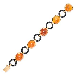 A RETRO CITRINE AND ONYX BRACELET in 18ct yellow gold, set with a row of alternating round caboch...