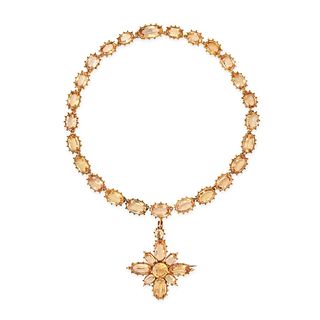 AN ANTIQUE IMPERIAL TOPAZ RIVIERE NECKLACE in high carat yellow gold, comprising a row of oval cu...