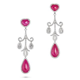 A PAIR OF RUBY AND DIAMOND DROP EARRINGS in white gold, each set with a heart shaped cabochon rub...