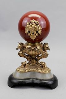 Carved Stone Ball on Figural Gilt Bronze Stand