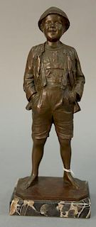 German bronze figure of a boy in knee length trousers and his hands in his pockets, signed on base indistinctly. ht. 11in.