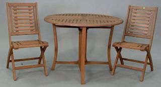 Teak three piece outdoor table set including pair of folding chairs and folding round table, ht. 30in., dia. 43in.