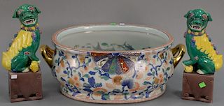 Large porcelain Imari wash basin with gilt handles (lg. 22in.) and pair of porcelain foo dogs (ht. 14in.).