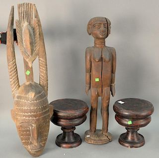 Four piece group to include to carved wood African pieces, tall nude figure (ht. 30in.), and carved horned mask.