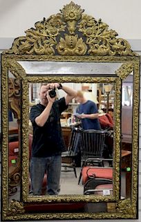 Baroque style embossed brass mirror, ht. 52in., wd. 33 1/2in.