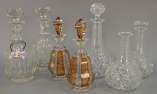 Seven crystal decanters including a set of three with twist glass necks and two pairs of decanters. ht. 7 1/2in. to 11 1/2in.