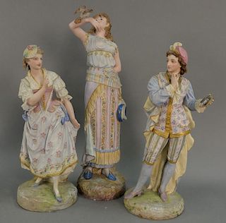Three large porcelain bisque figures, all elaborately paint decorated with gilt highlights (two with repairs). ht. 19in., 19i