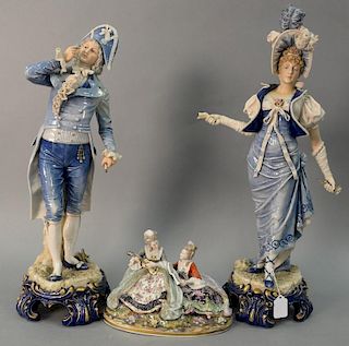 Three porcelain figurines including a pair of large English porcelain figurines a Victorian man and woman blue and white with