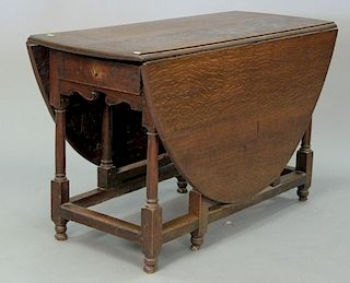Oak gateleg drop leaf table, opens with oval top, ht. 28in., open: 49" x 62".