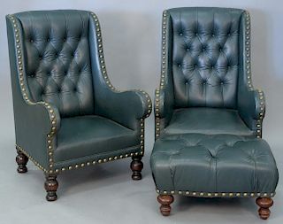 Three piece lot to include a pair of leather upholstered armchairs and near matching footstools.