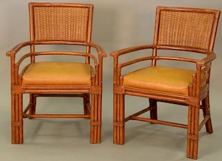 Set of five rattan and woven armchairs with leather seats.