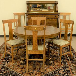 Eight piece oak Victorian dining set with round claw foot table and 3 leaves, six T back chairs, and sideboard. table ht. 29i