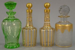 Four crystal bottles with stoppers including pair of crystal gilt decorated bottles each having etched #16 and 62 (possibly B