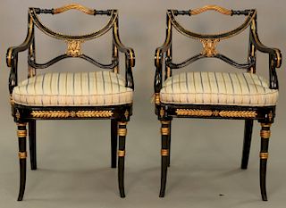 Pair of decorative armchairs with caned seats and custom upholstered cushions.