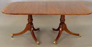Custom mahogany dining table with double pedestal and banded inlaid top with two 22inch leaves and pads (sun faded). ht. 30in