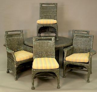Eight piece lot to include wicker table, four armchairs, two side chairs, and a sofa. table: ht. 29in., dia. 48in.