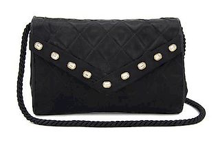 A Chanel Black Quilted Satin Flap Bag, 8 x 6 x 1 1/2 inches.