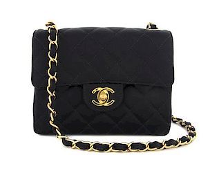 A Chanel Black Quilted Satin Mini Flap Bag, 6 1/2 x 5 x 2 1/2 inches.