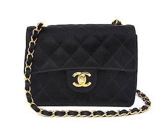 A Chanel Black Quilted Satin Mini Flap Bag, 7 x 5 x 2 1/4 inches.