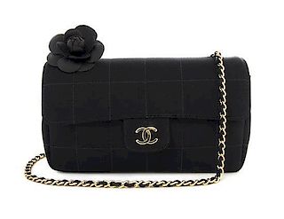 A Chanel Black Quilted Satin and Black Camellia Mini Flap Bag, 7 x 4 x 2 1/2 inches.
