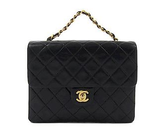 A Chanel Black Lambskin Mini Flap Bag, 8 x 6 x 2 1/2 inches.