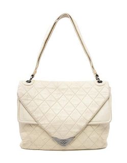 A Chanel Ivory Quilted Leather Bag, 13 x 10 1/2 x 3 inches.
