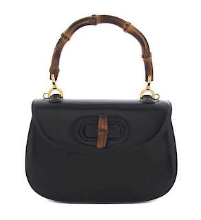 A Gucci Black Leather and Bamboo Handle Bag, 8 1/2 x 6 x 2 1/4 inches.