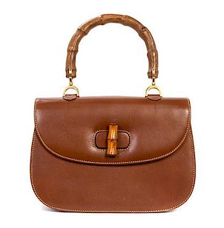 A Gucci Brown Leather and Bamboo Handle Bag, 11 x 7 1/2 x 3 1/2 inches.