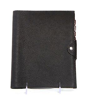 An Hermes Black Leather Address Book, 9 x 7 x 1 inches.