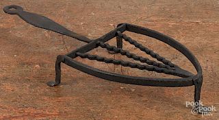 Wrought iron trivet, 19th c., 13 1/2'' l., together with a peel, 32 1/2'' l.