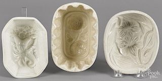 Two floral pattern food molds, together with a cornucopia example, largest - 3 1/2'' h., 7'' w.