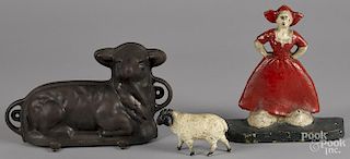 Cast iron lamb food mold, 7 1/4'' h., 11 1/2'' w., together with a Dutch girl doorstop