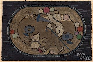 American hooked rug, early 20th c., with a boy playing a trumpet, 27'' x 40''.