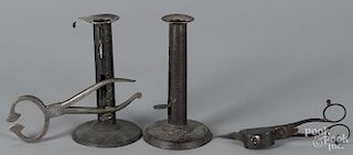 Two hogscraper candlesticks, 6 1/4'' h., together with sugar nippers and a scissor snuffer.