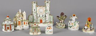 Eight pieces of Staffordshire, to include a castle, 8 1/4'' h., spill vases, pastille burners, etc.