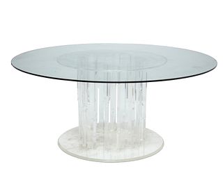 A Lucite pedestal dining table