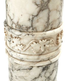 A carved Carrera marble lighted pedestal