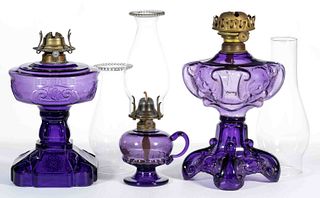 ASSORTED IRRADIATED GLASS KEROSENE LAMPS, LOT OF THREE
