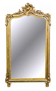 * A Rococo Style Giltwood Mirror Height 63 inches.